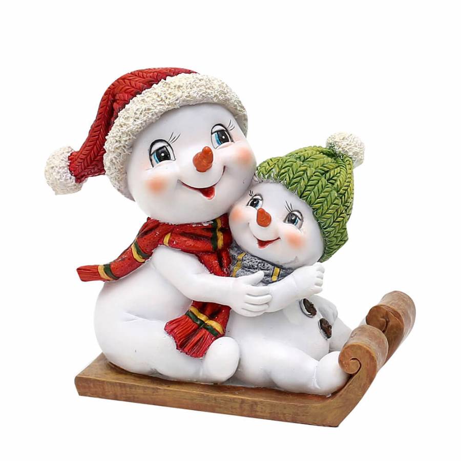zwei lächelnde Schneemänner mit strahlenden blauen Augen auf einem Schlitten