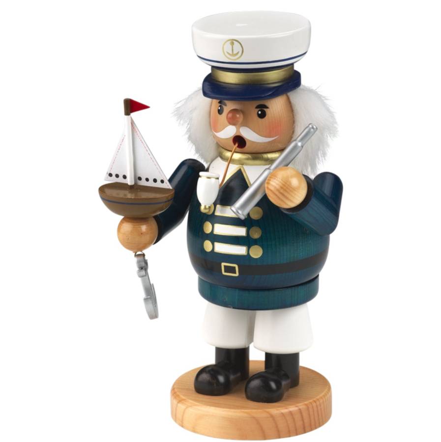 Räucherfigur raeuchermaennchen Kapitän in weißer Uniform und Kapitänsmütze. Braunes Seuerrrad vor sich und ein schwarzes Fernglas in der Hand